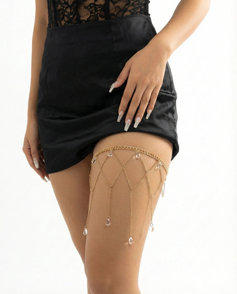 Gold lattice thigh chain with crystal drops on upper thigh front view