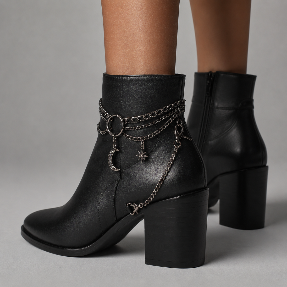 Gothic boot chain with crescent moon and star charms styled on heeled ankle boots - side angle