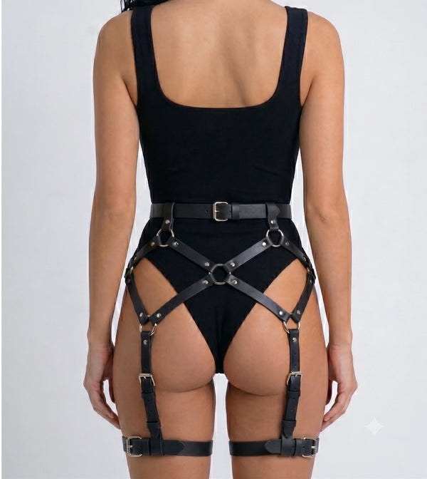 Black faux leather booty harness framing the hips and upper thighs, rear view