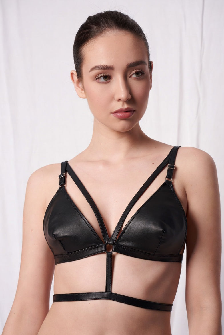 Black faux leather harness bralette front view with triangle cup panels and straps