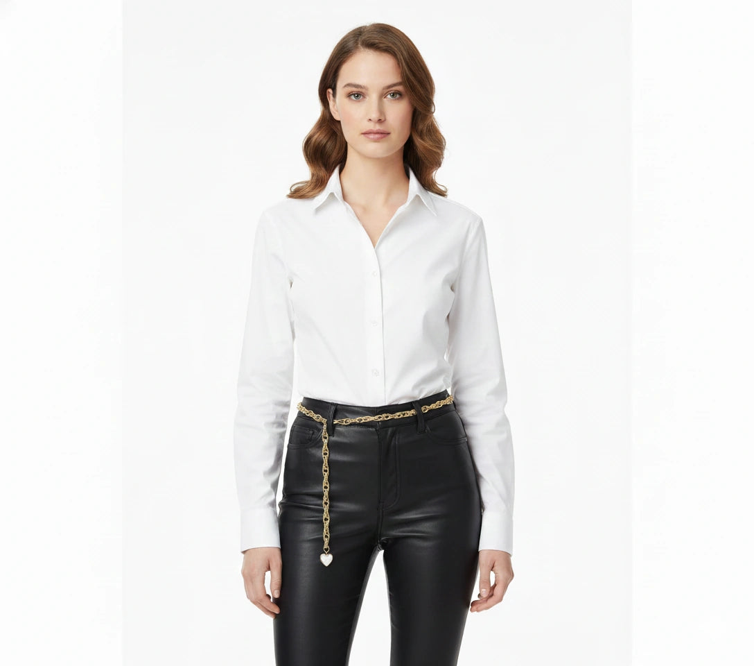 Gold-tone heart waist chain worn over black trousers, front view